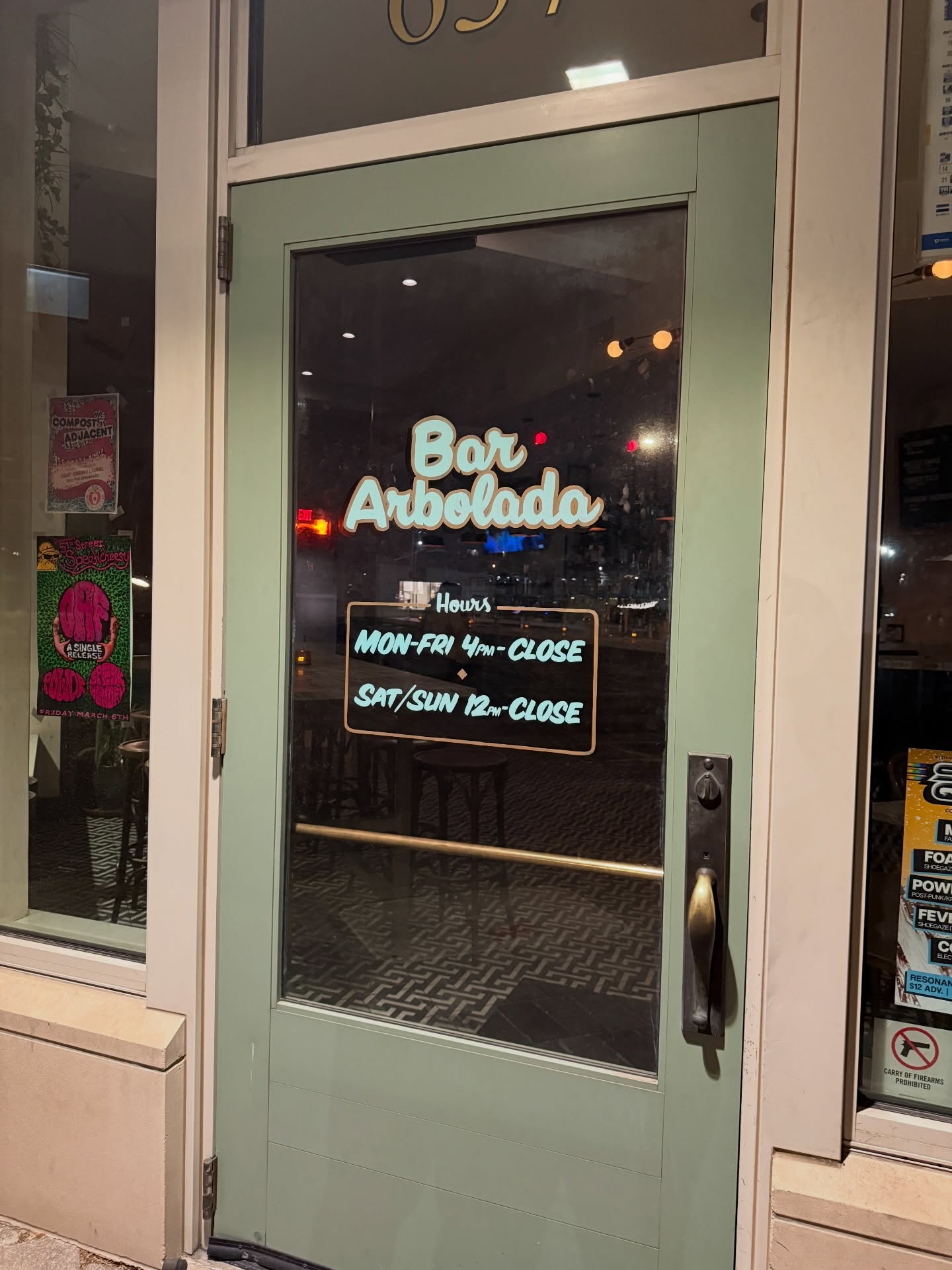 The storefront door of Bar Arbolada on W Main Street, Oklahoma City