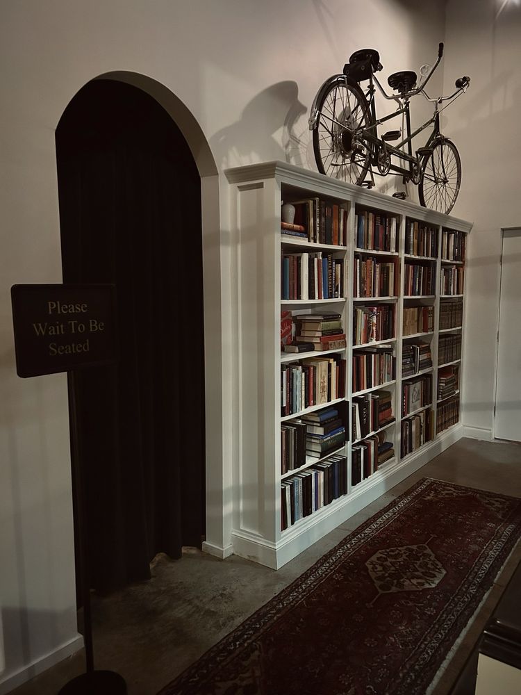 The bookcase entrance to Good For A Few speakeasy in the Plaza District