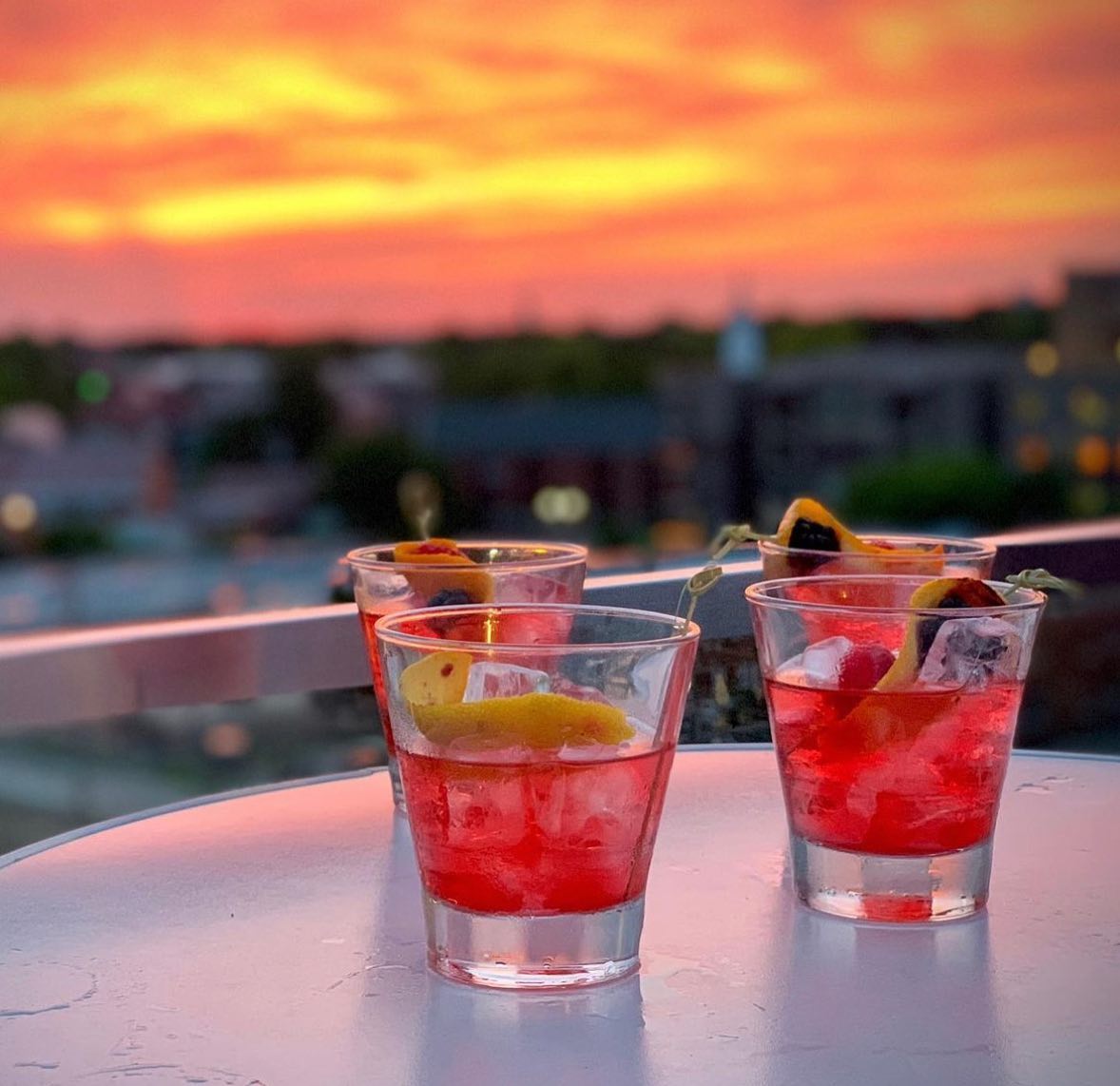 Red cocktails on the O Bar rooftop at sunset